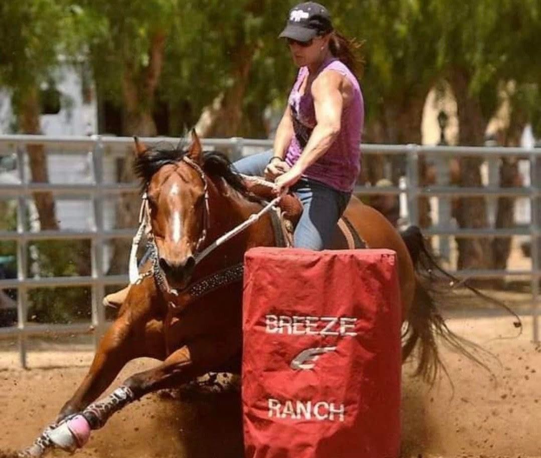 Woman barrel racing on a chestnut horse at a local equestrian event, perfect for those searching for barrel racing near me.