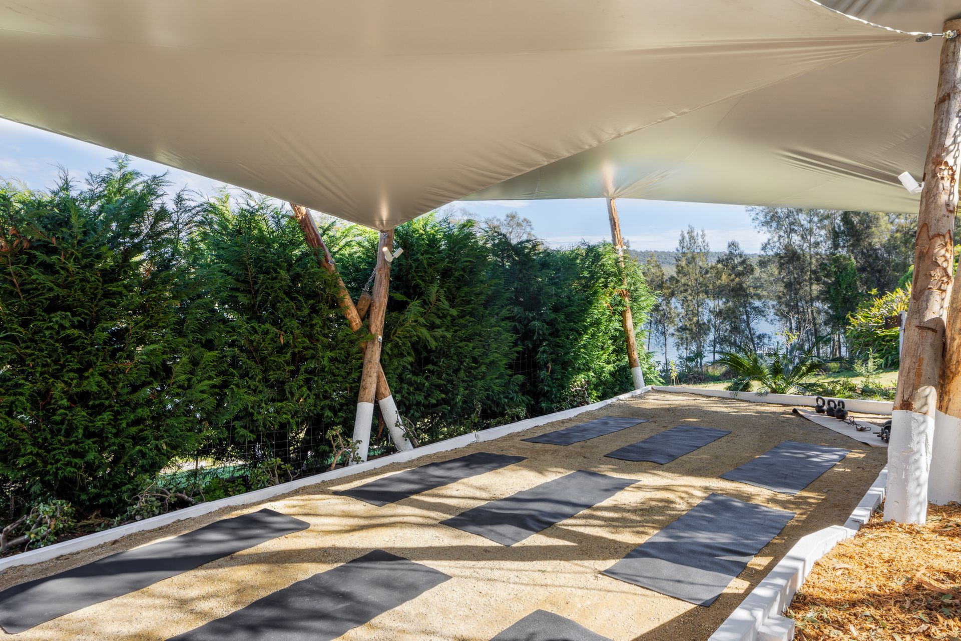 A carport with a canopy over it and a view of a lake.