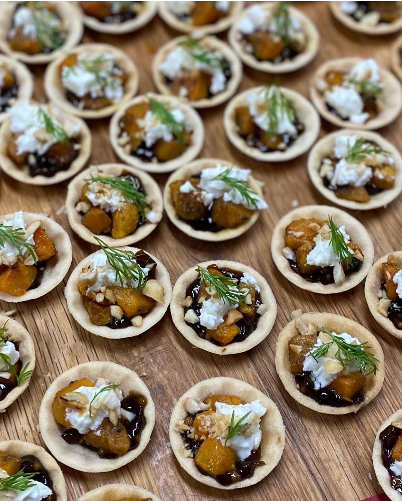 A bunch of appetizers are sitting on a wooden table.