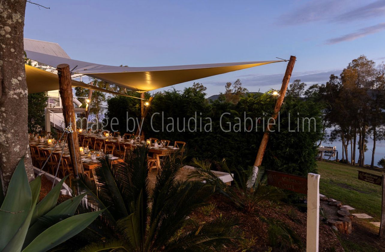 A picture of a restaurant with tables and umbrellas taken by claudia gabriel lim