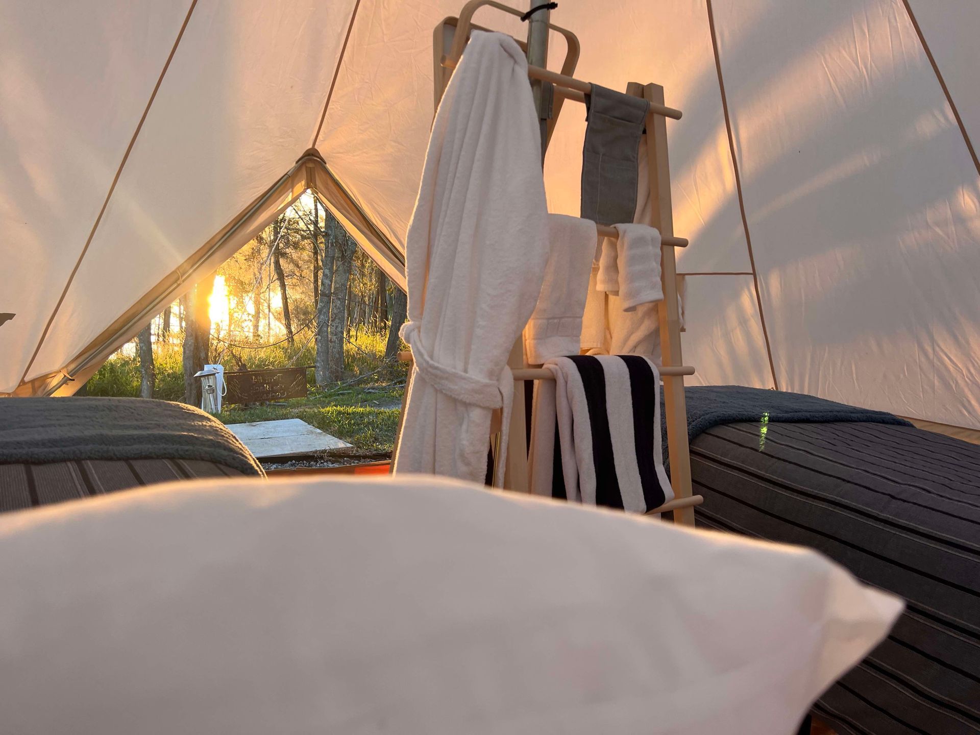 A tent with a ladder and towels hanging from it