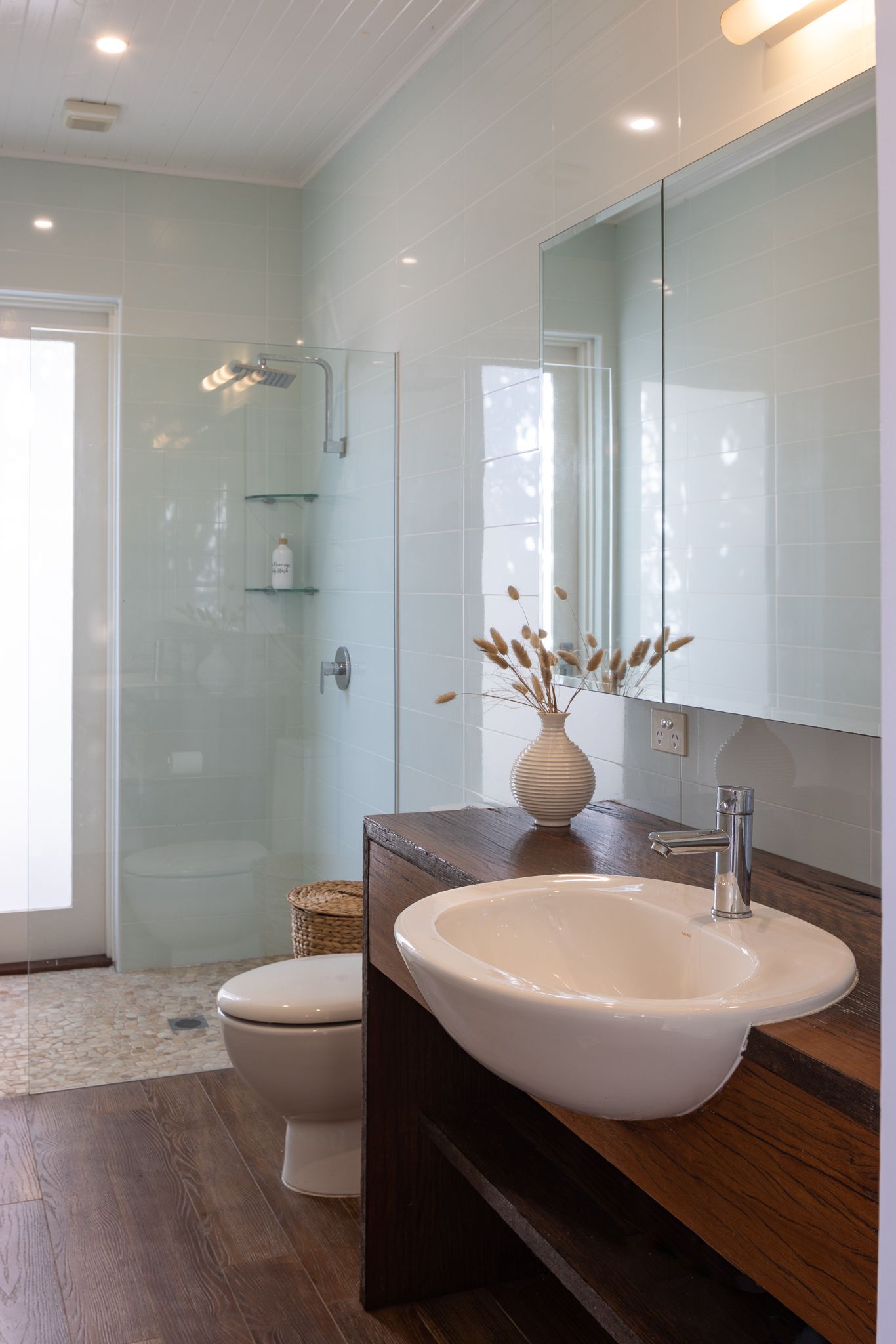 A bathroom with a sink a toilet and a walk in shower