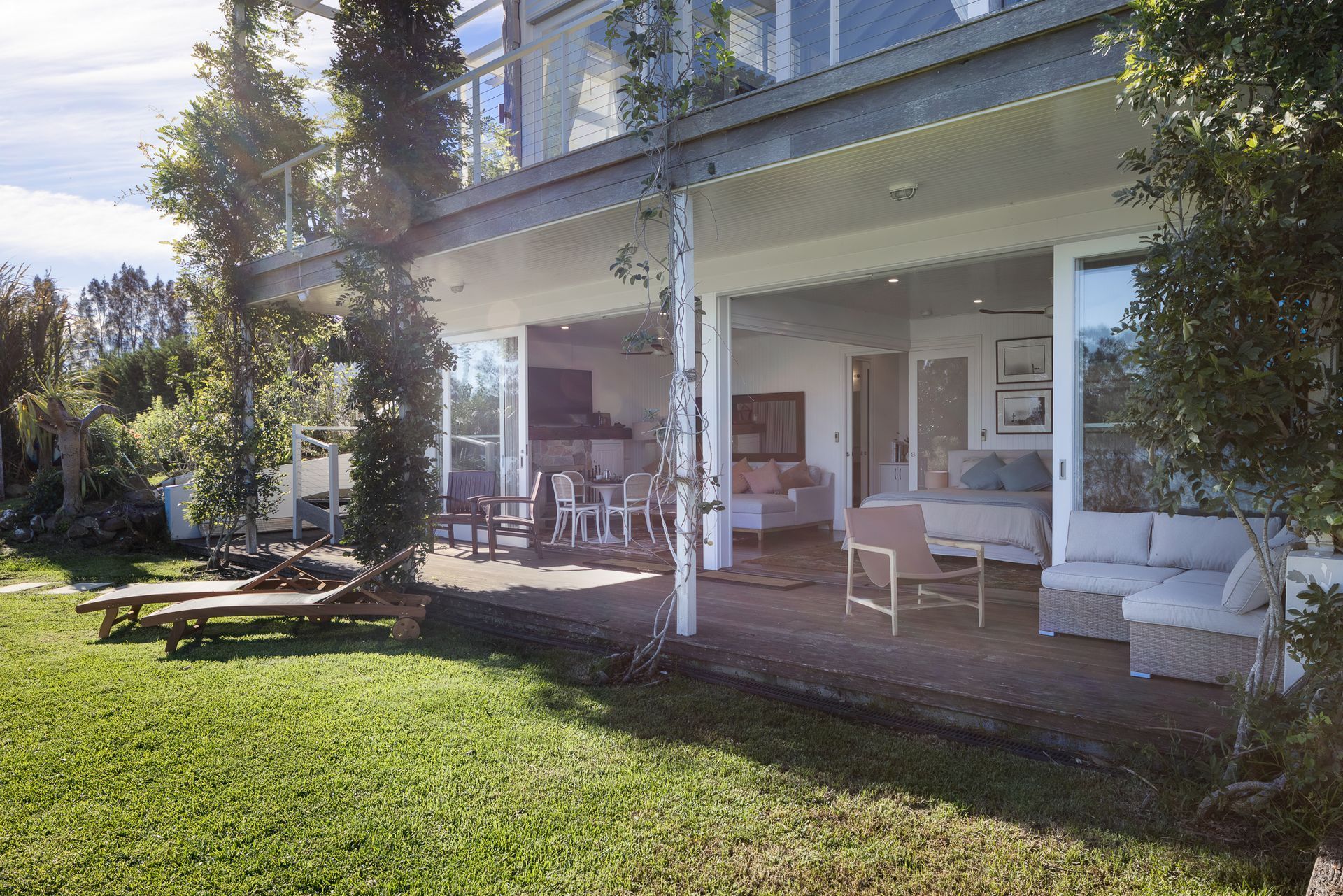 A large house with a lot of windows and a patio in front of it.