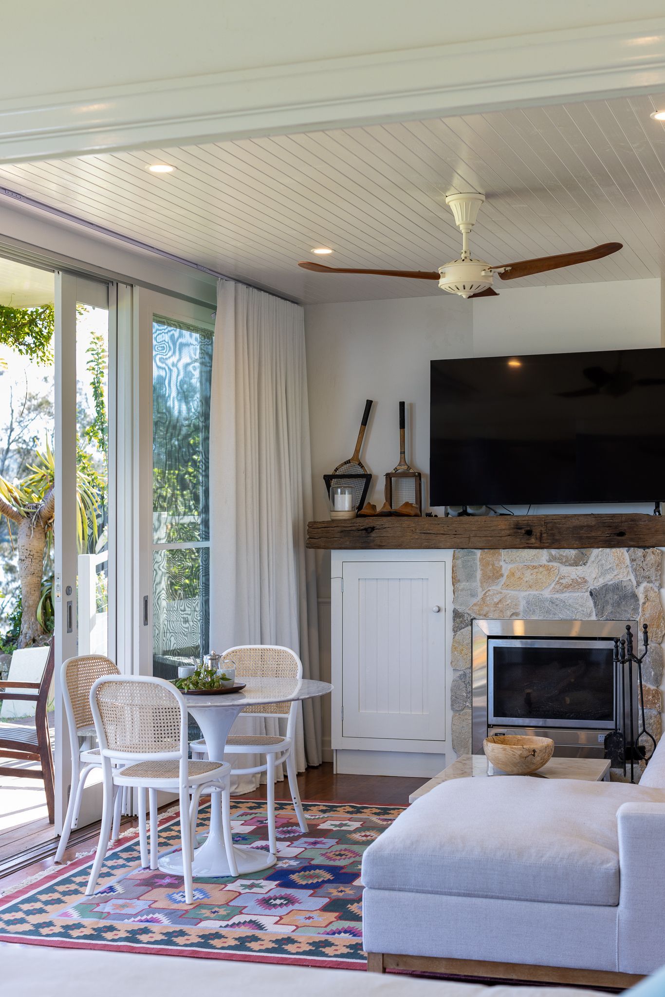 A living room with a fireplace and a flat screen tv