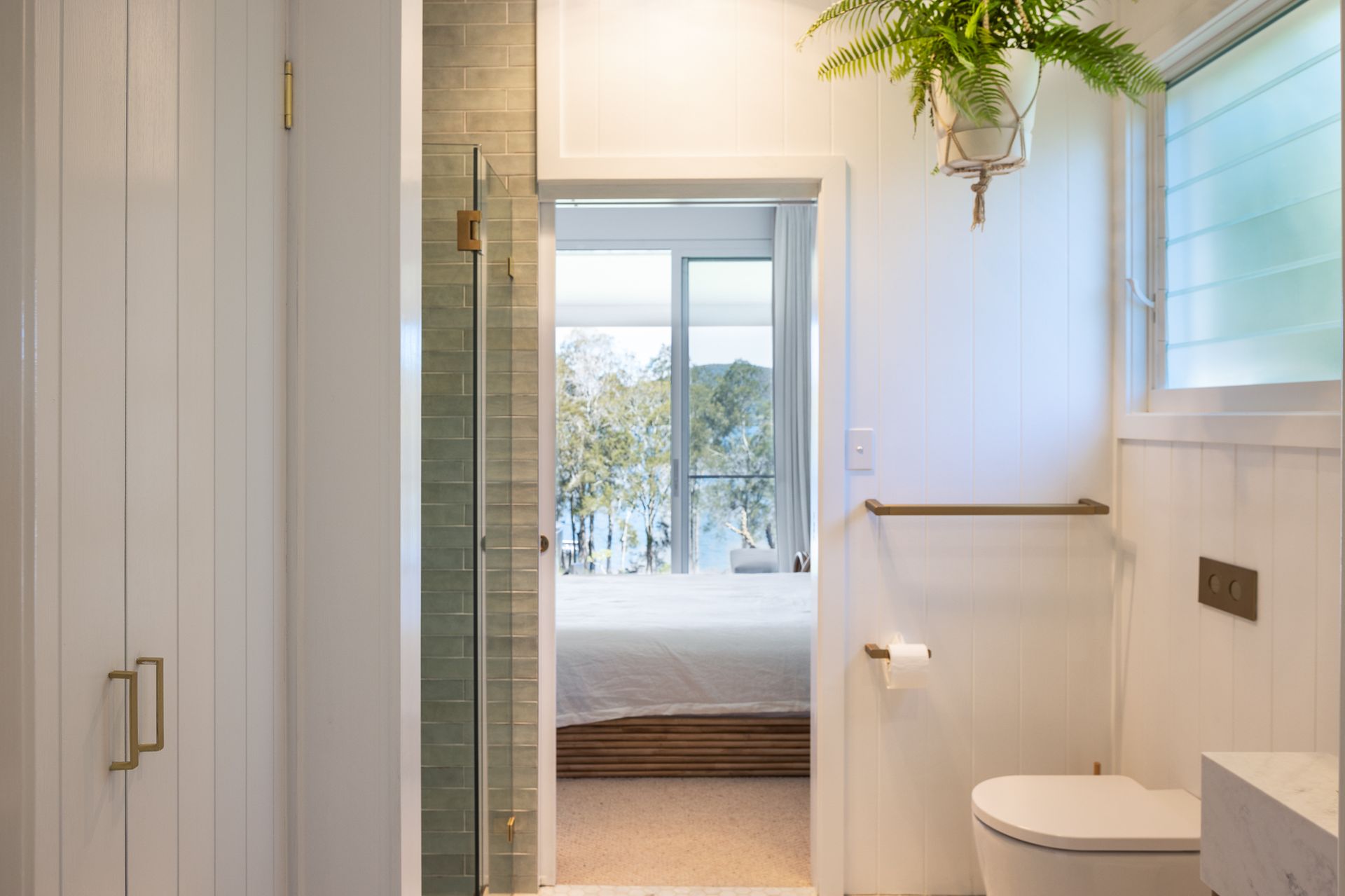 A bathroom with a toilet , shower and bathtub.