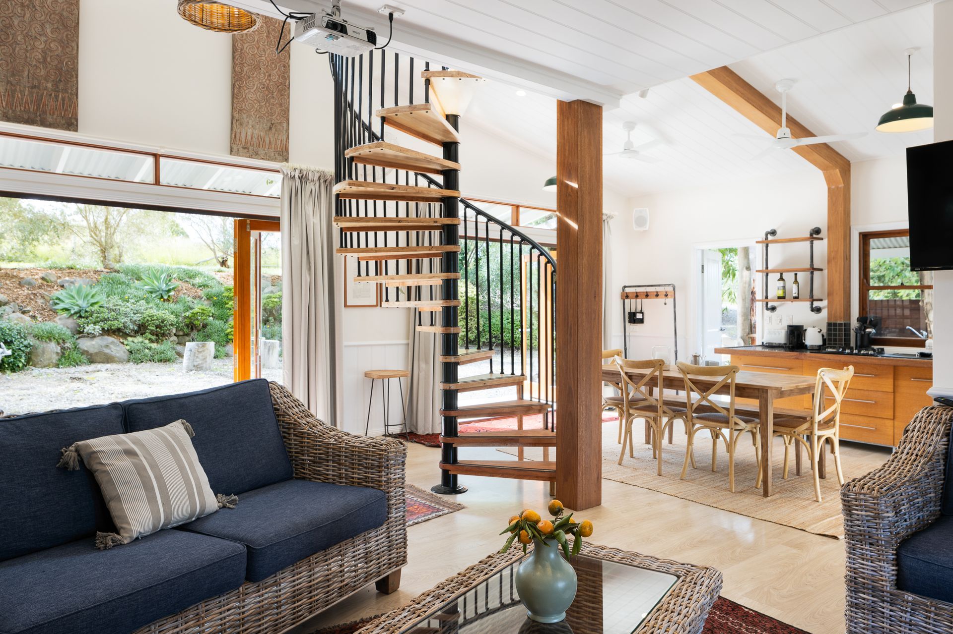 A living room with a spiral staircase and a couch
