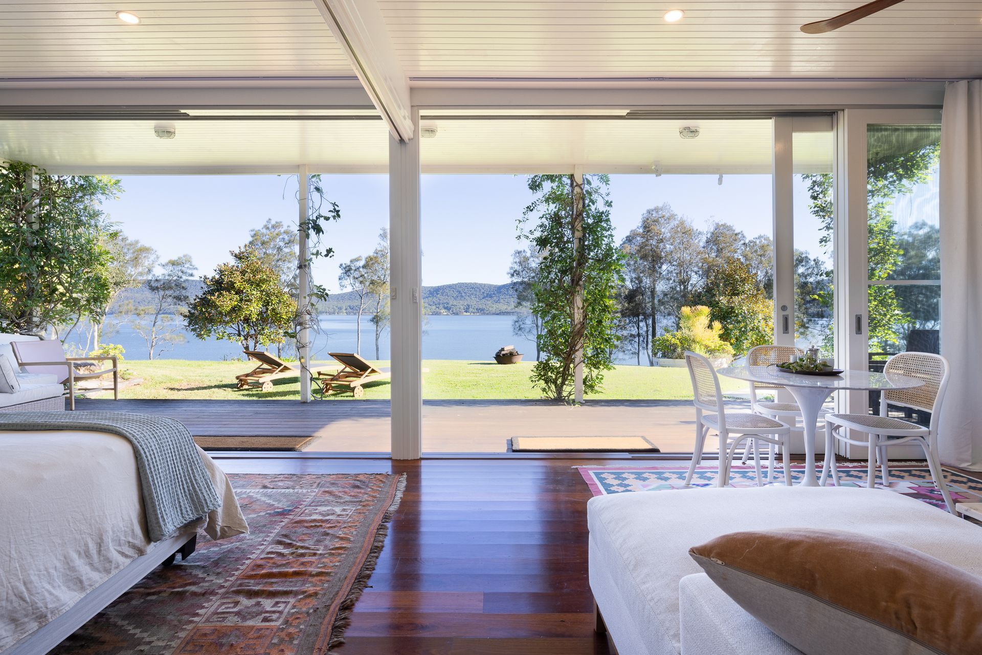 A bedroom with two beds and a view of a lake