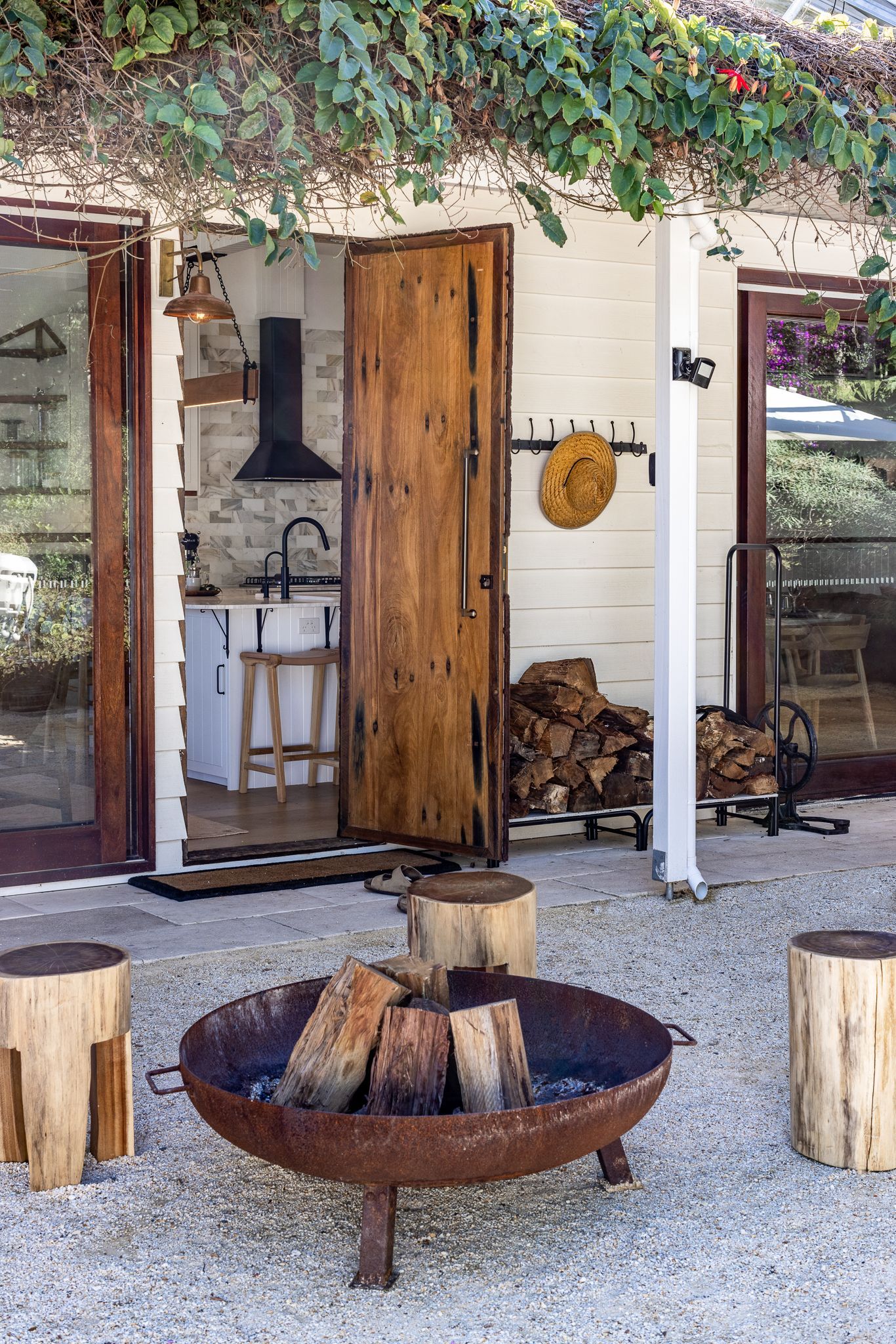 A fire pit is sitting in front of a house.