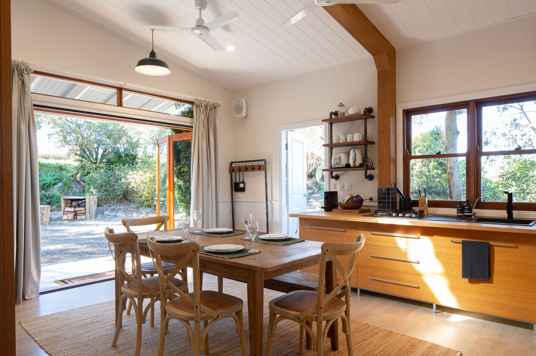 A kitchen with a table and chairs and a ceiling fan