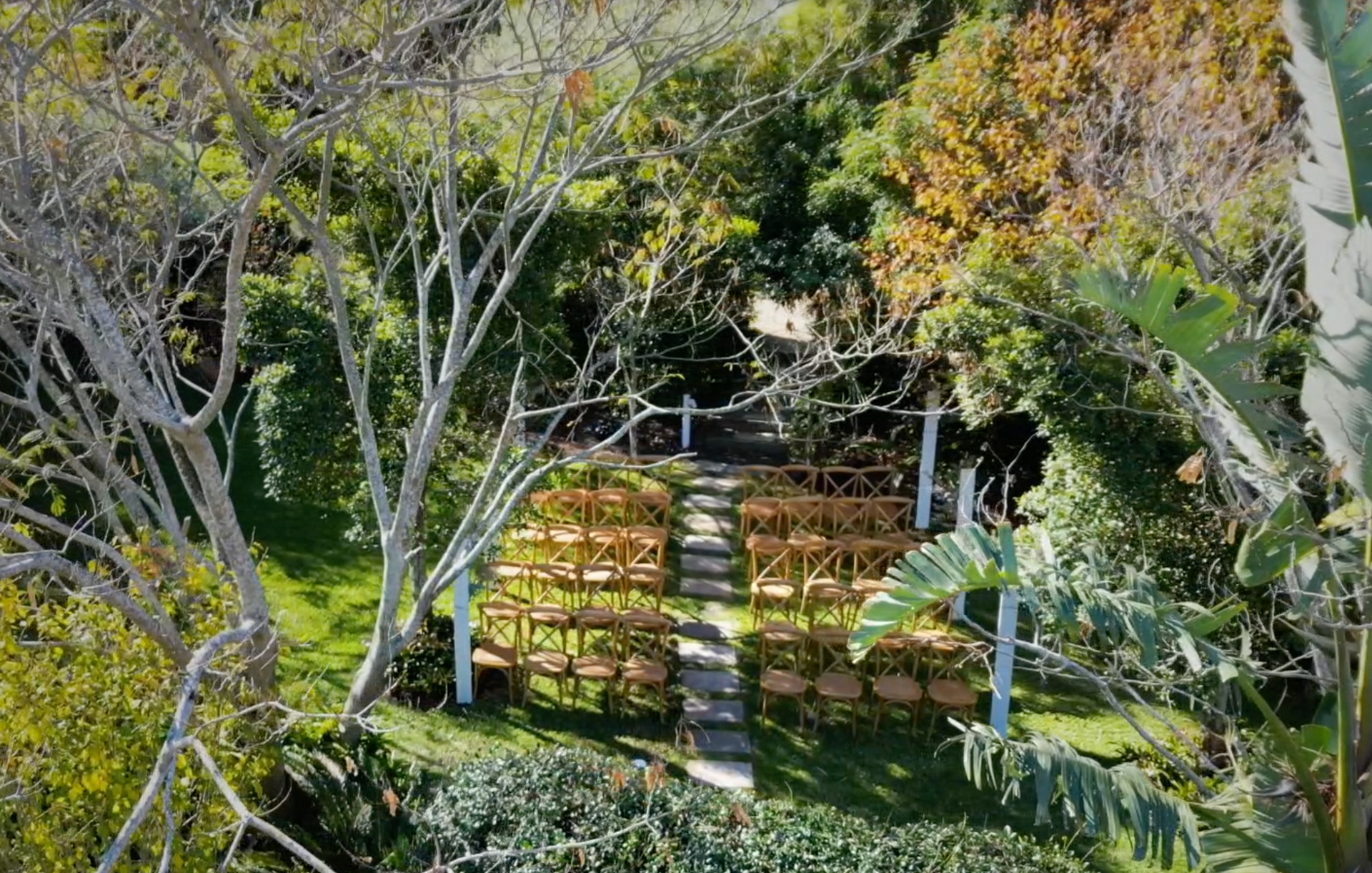 An aerial view of a wedding ceremony in a forest.