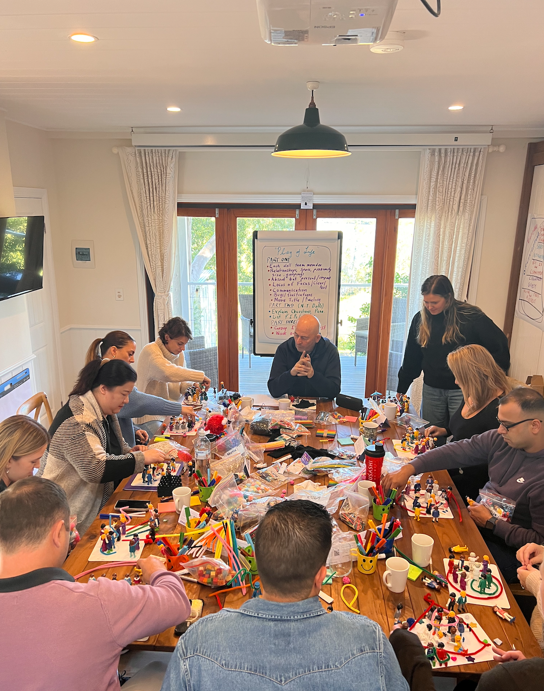 A group of people are sitting around a table in a room.