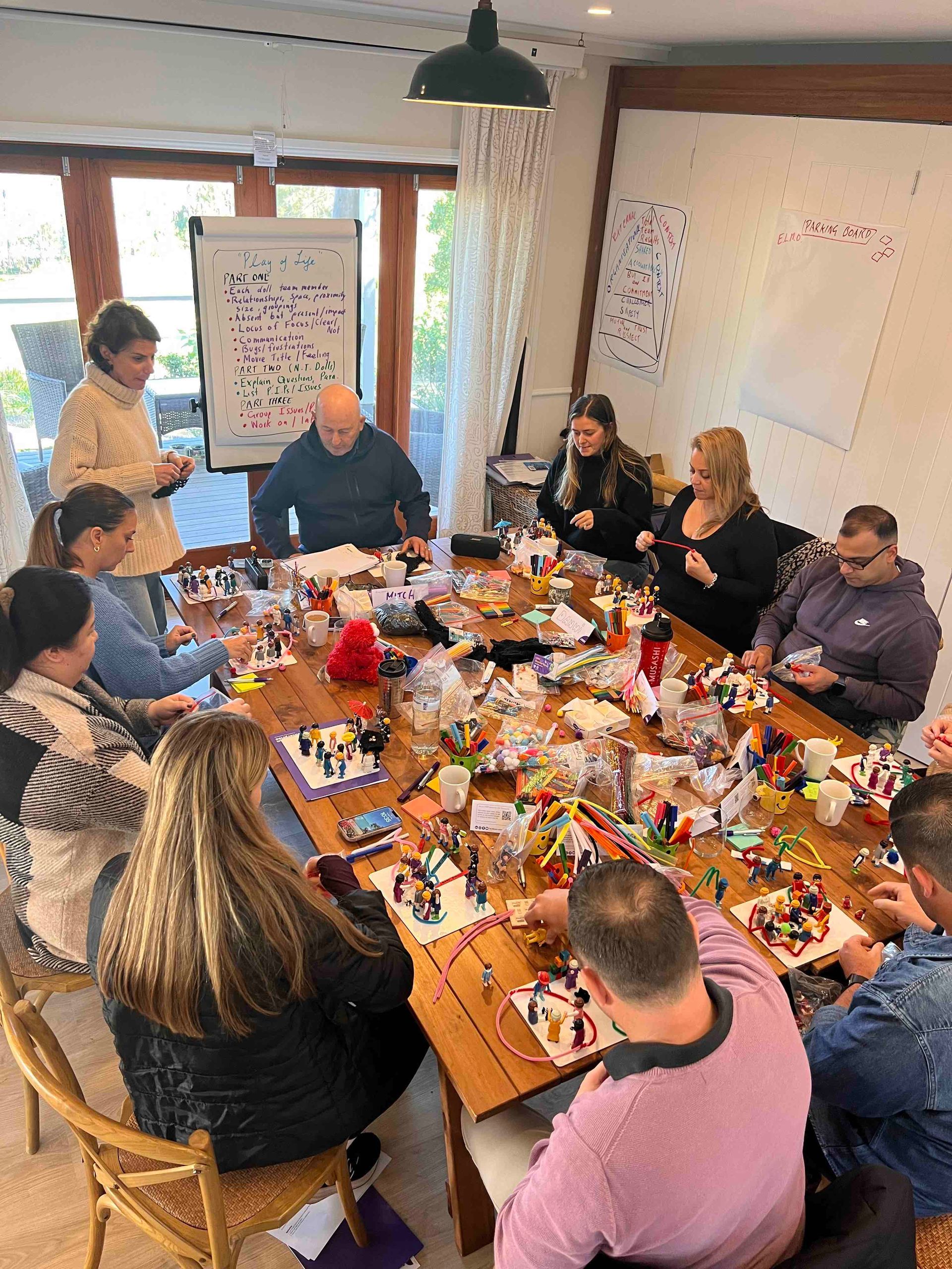 A group of people are sitting around a table in a room.