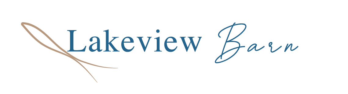 A logo for lakeview barn with a needle and thread.