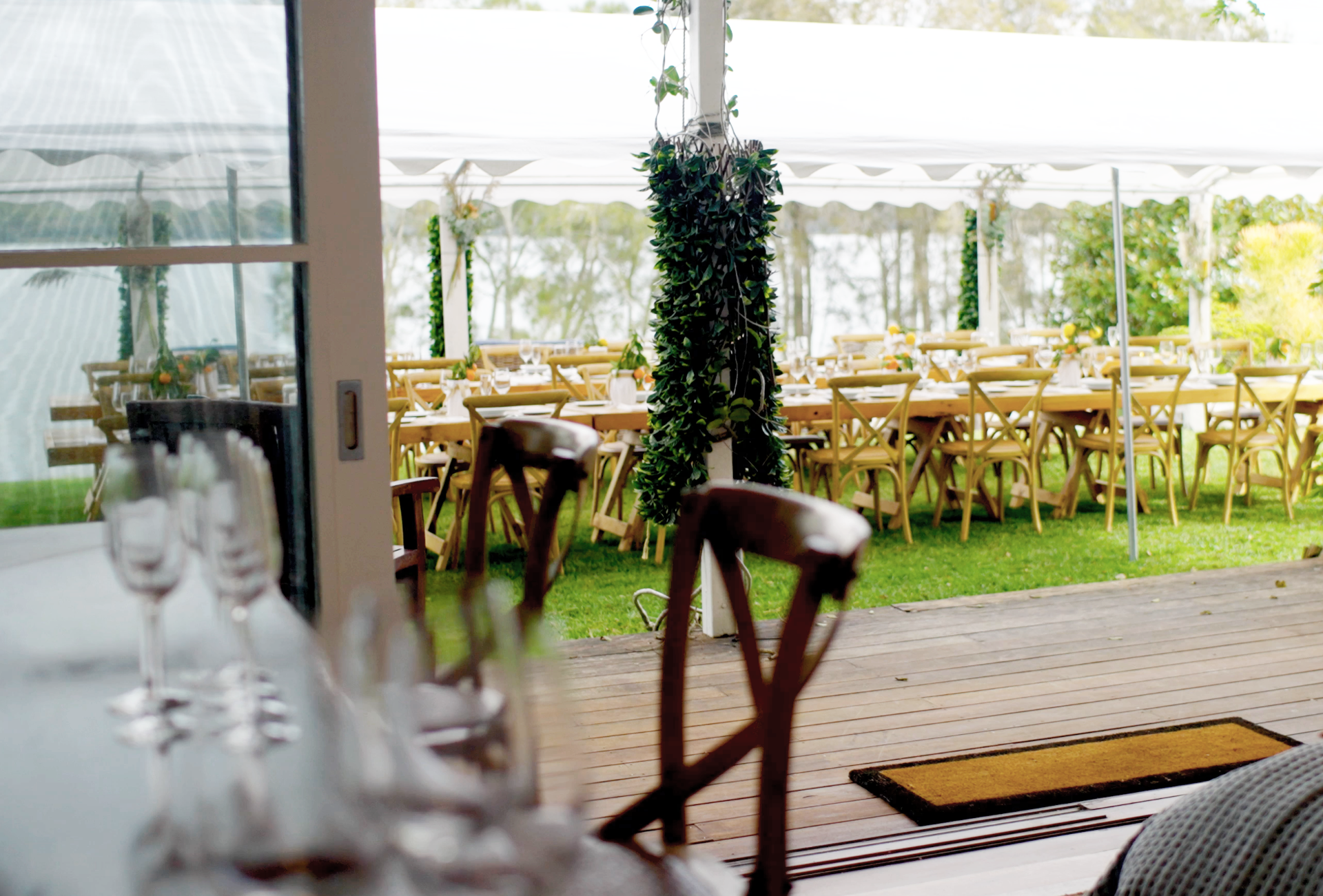 A patio with tables and chairs and a tent in the background