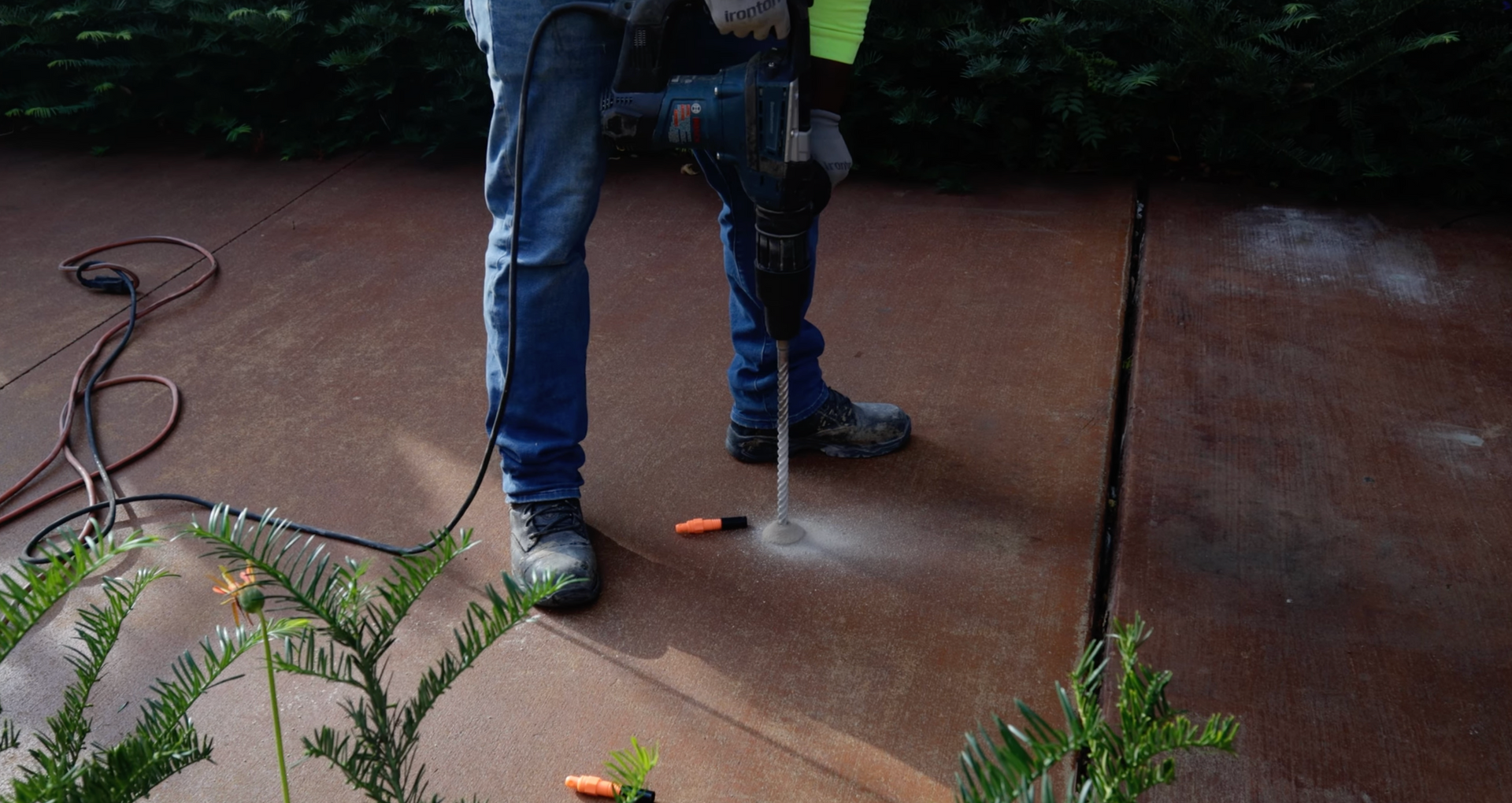 man drilling holes in concrete prepping for lifting a slab in fort worth TX