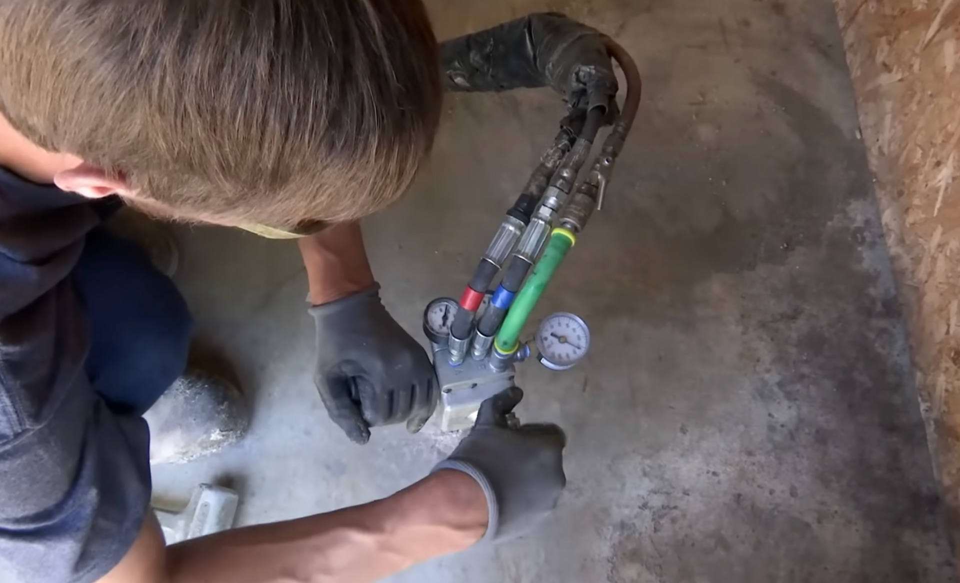 man drilling hole to inject concrete foam lifting material