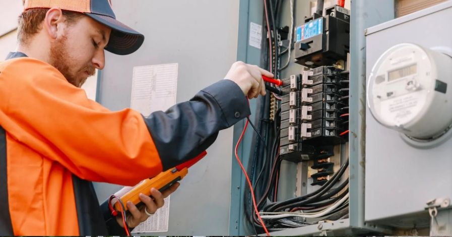 Professional electrician performing a residential electrical panel upgrade.
