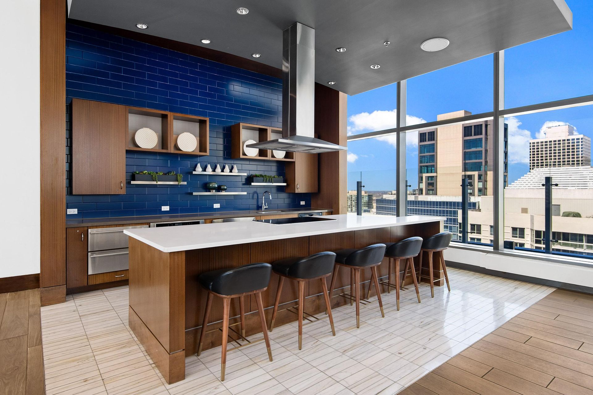 a kitchen with a bar and a view of a city