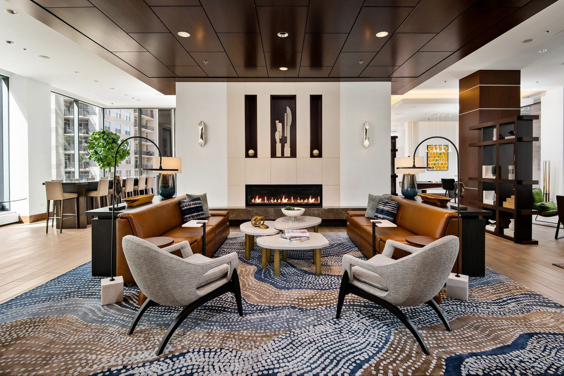 a living room with couches and chairs and a fireplace