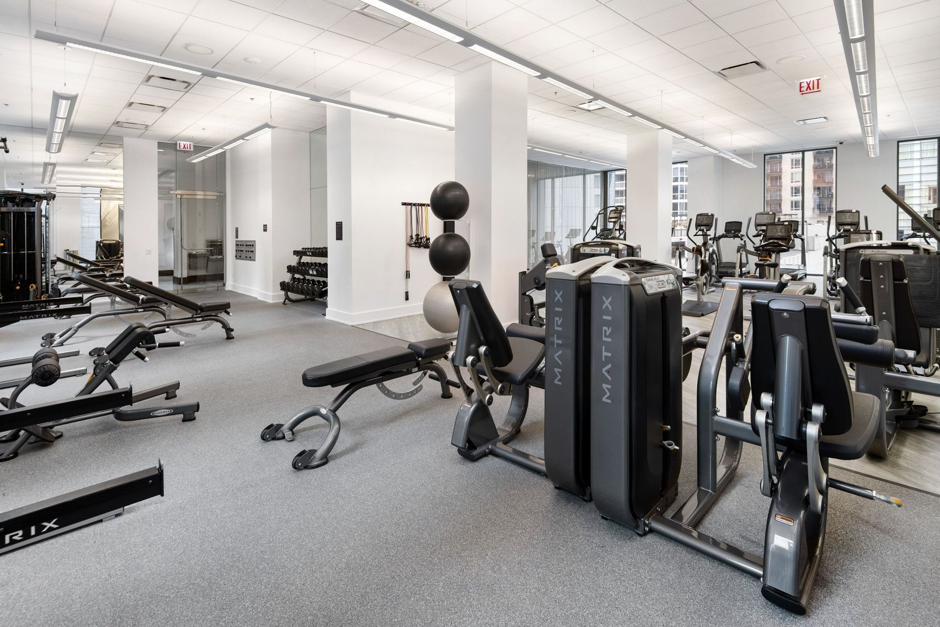 a gym with weights and other exercise equipment in a large room