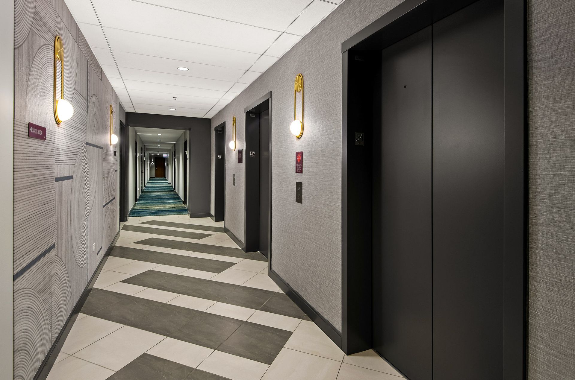 a corridor of elevators and doors in a building