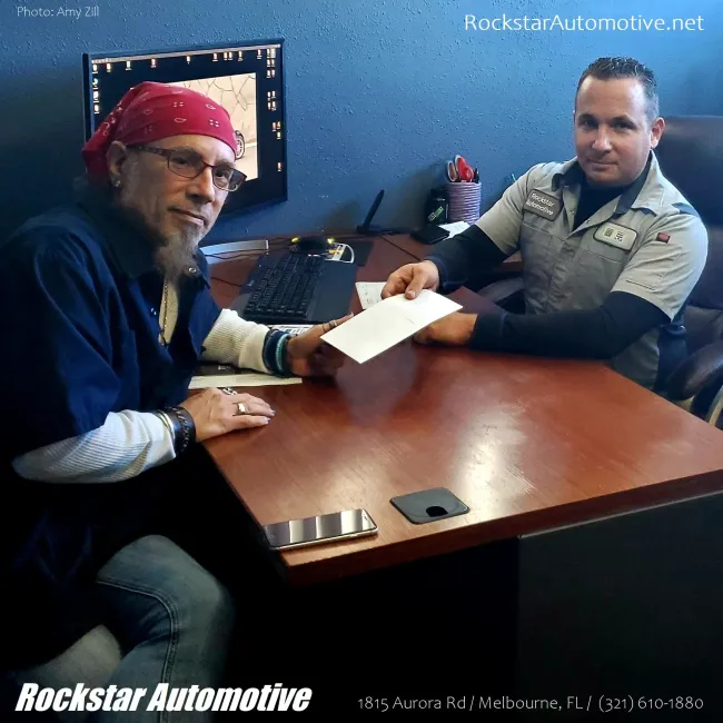 The Owner of Rockstar Automotive with a Client in Melbourne, FL