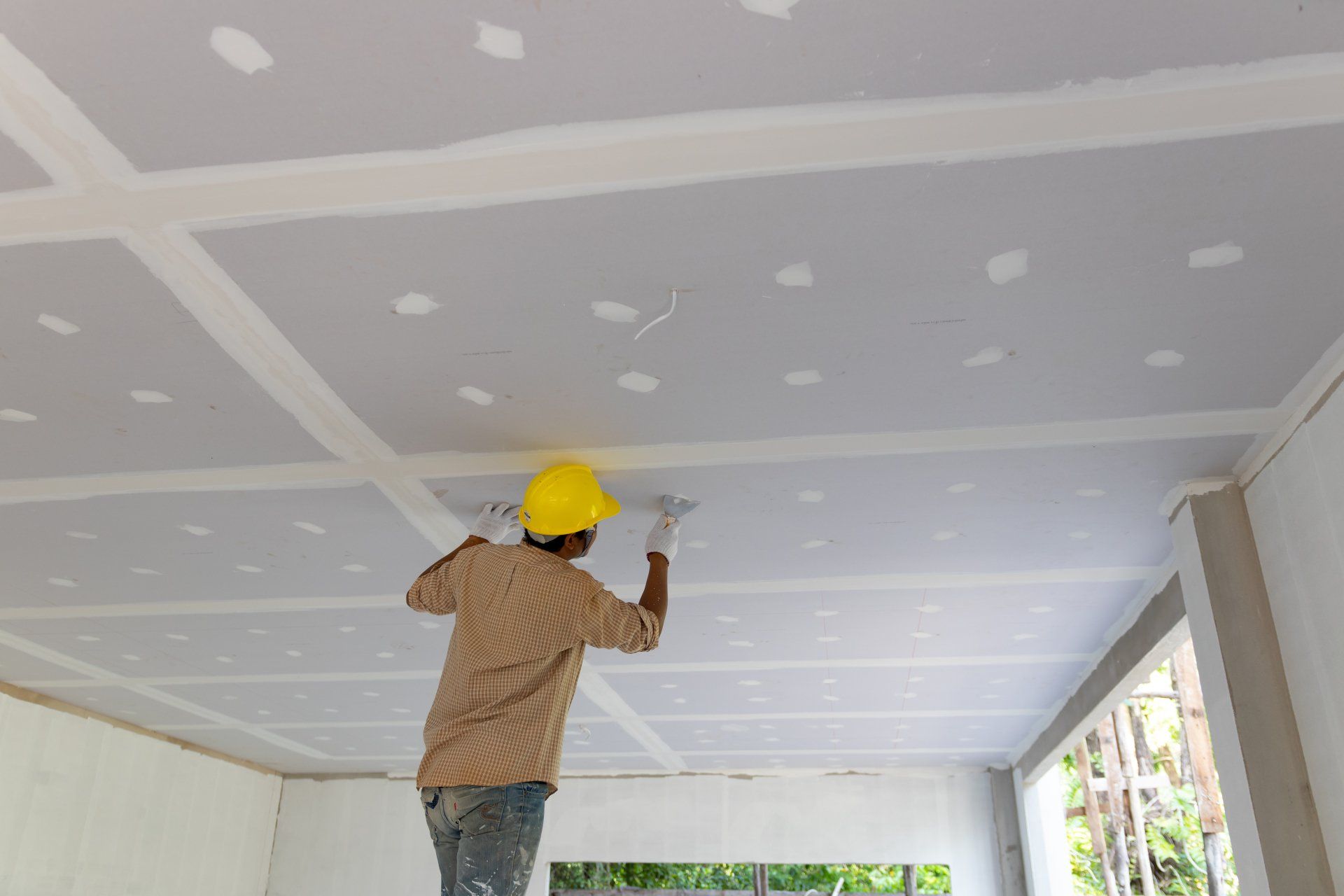 Construction man worker plaster gypsum ceiling for interior build gypsum board ceiling