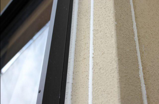 “Close-up of textured stucco trim beside a window frame showing clean vertical detail from a stucco service in Spring Valley, NV”