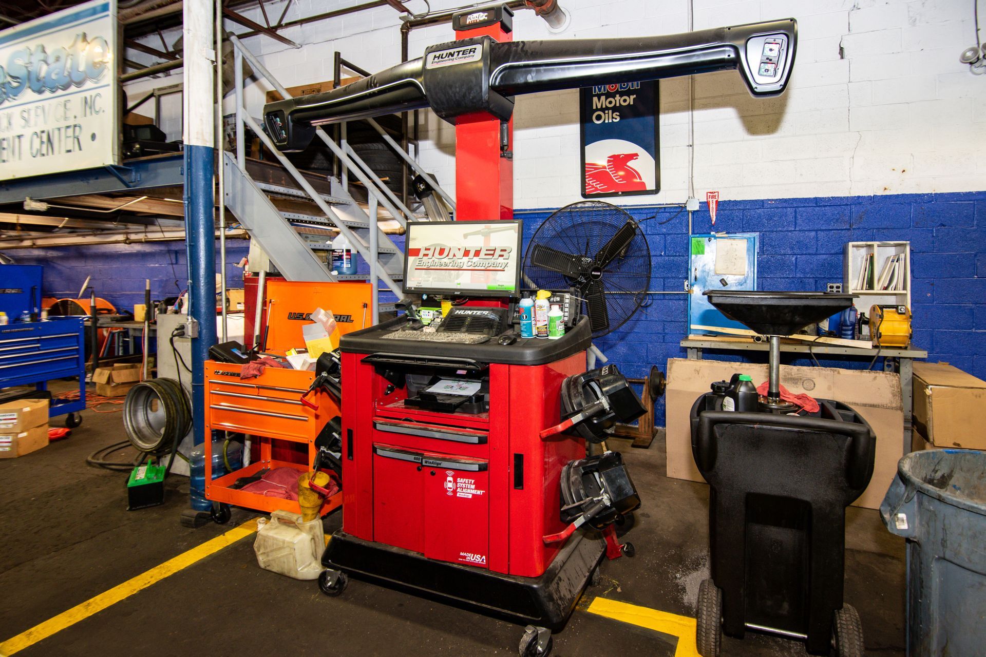 Red alignment machine in auto repair shop with tools and equipment | Freestate Auto & Truck Service