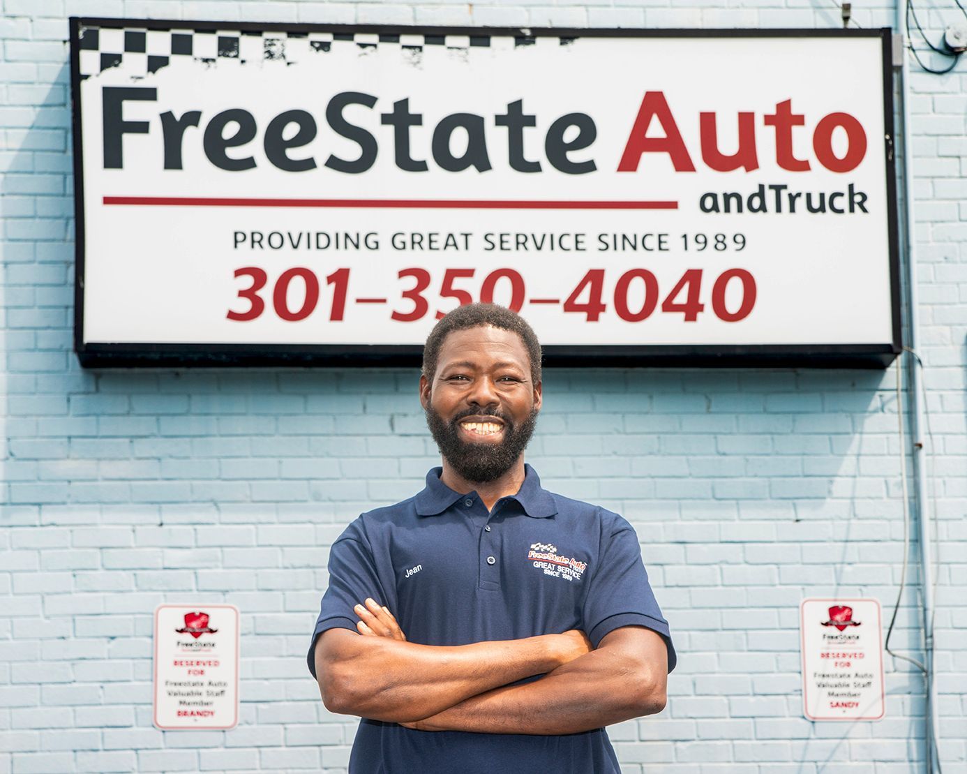 Owner standing outside our shop under sign | Freestate Auto & Truck Service