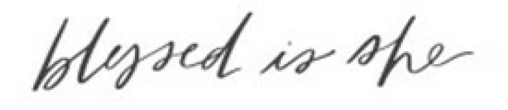 Handwritten script reading “blessed is she” in black ink on a white background