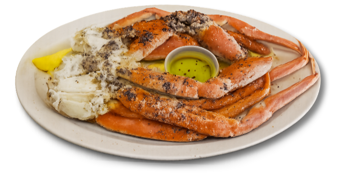 Plate of cooked snow crab legs with melted butter and lemon.