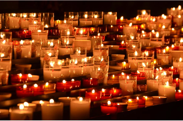 Several lit candles symbolizing funerals and cremations