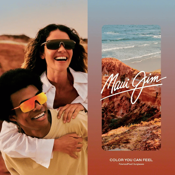A man is carrying a woman on his back wearing maui jim sunglasses