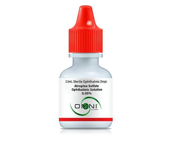 Red-capped white eye drop bottle labeled “DOMI” on a plain background