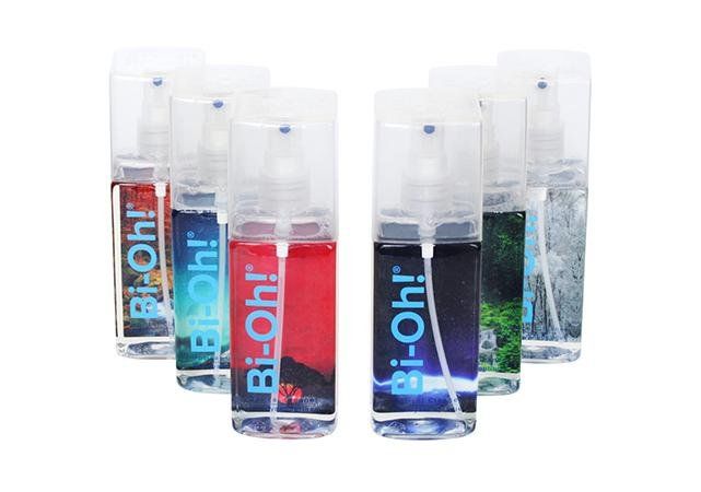 A group of spray bottles are stacked on top of each other in the shape of a heart.
