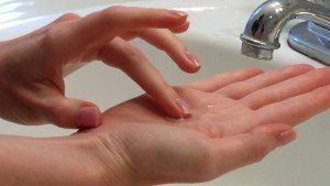 A person is washing their hands in a sink.