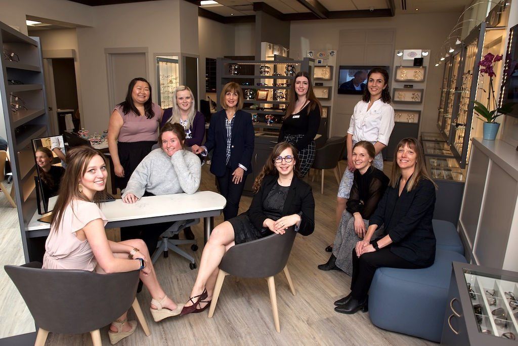 A group of women are posing for a picture in a room.