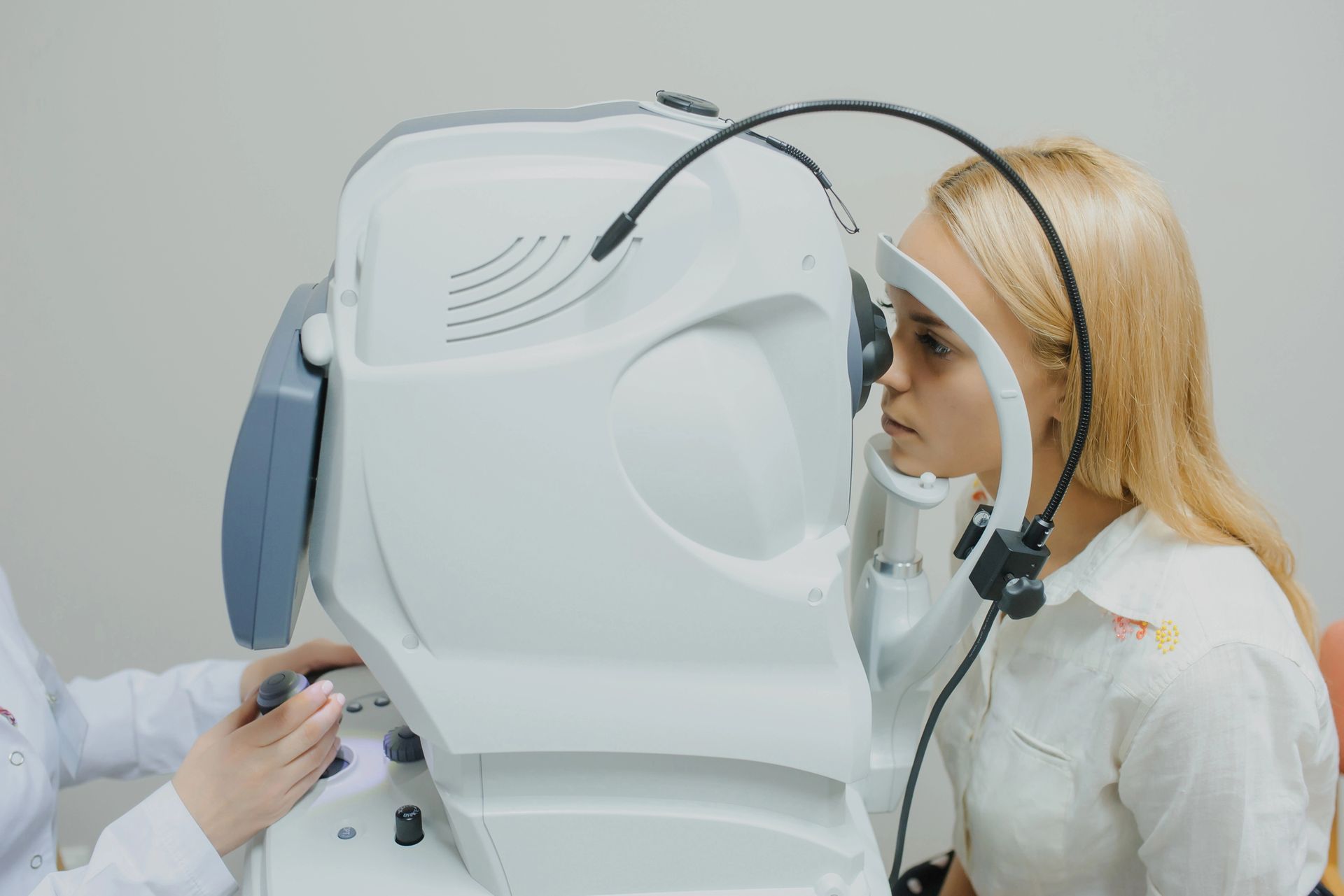 A woman is getting her eyes examined