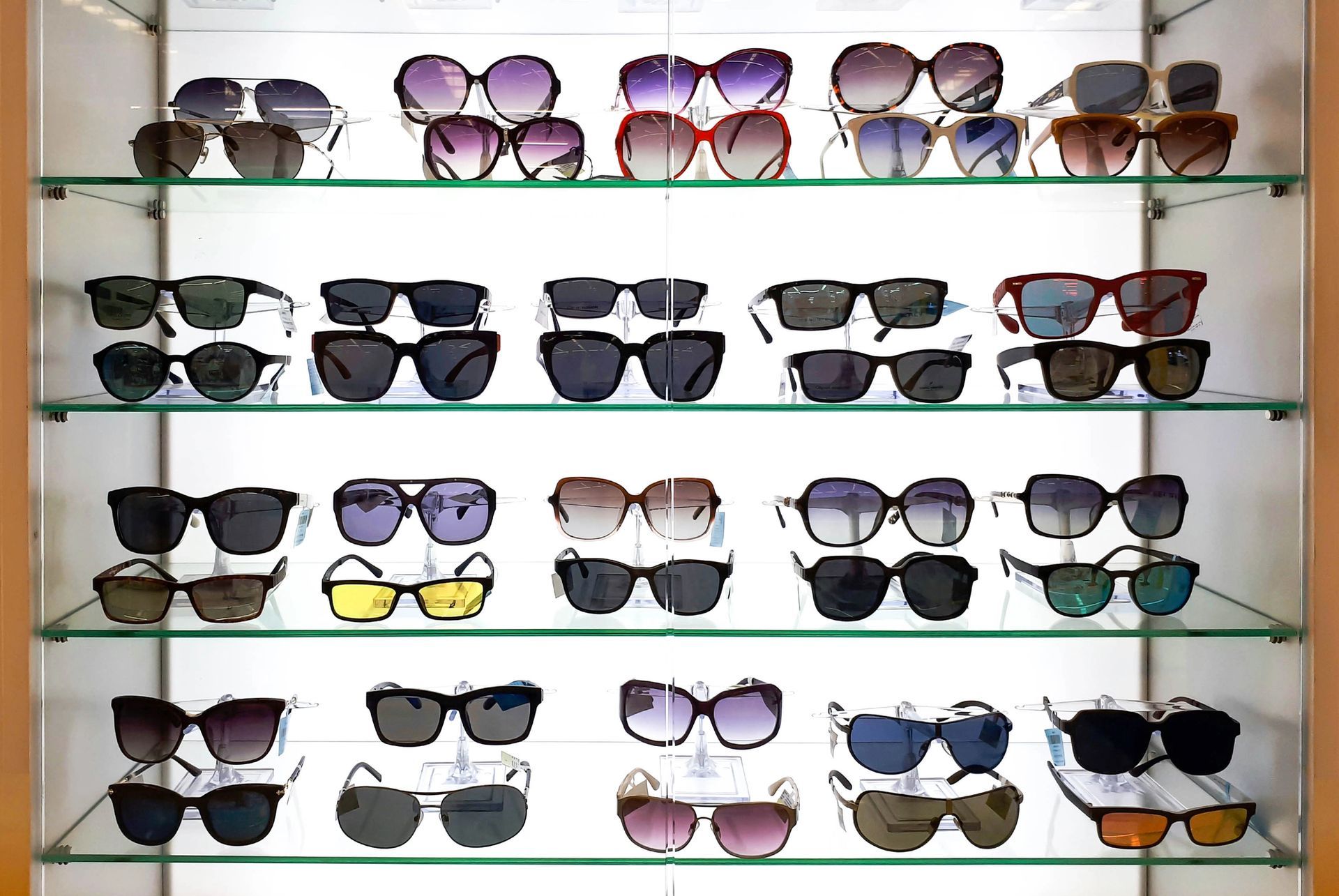 A display case filled with lots of different types of sunglasses.