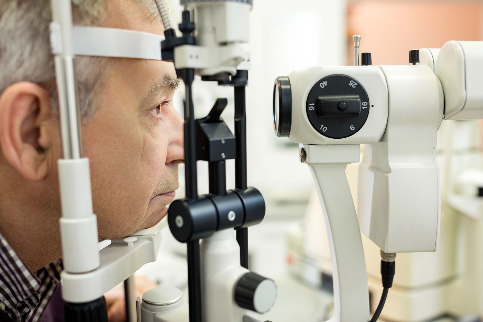 A man is getting his eyes examined by an ophthalmologist.