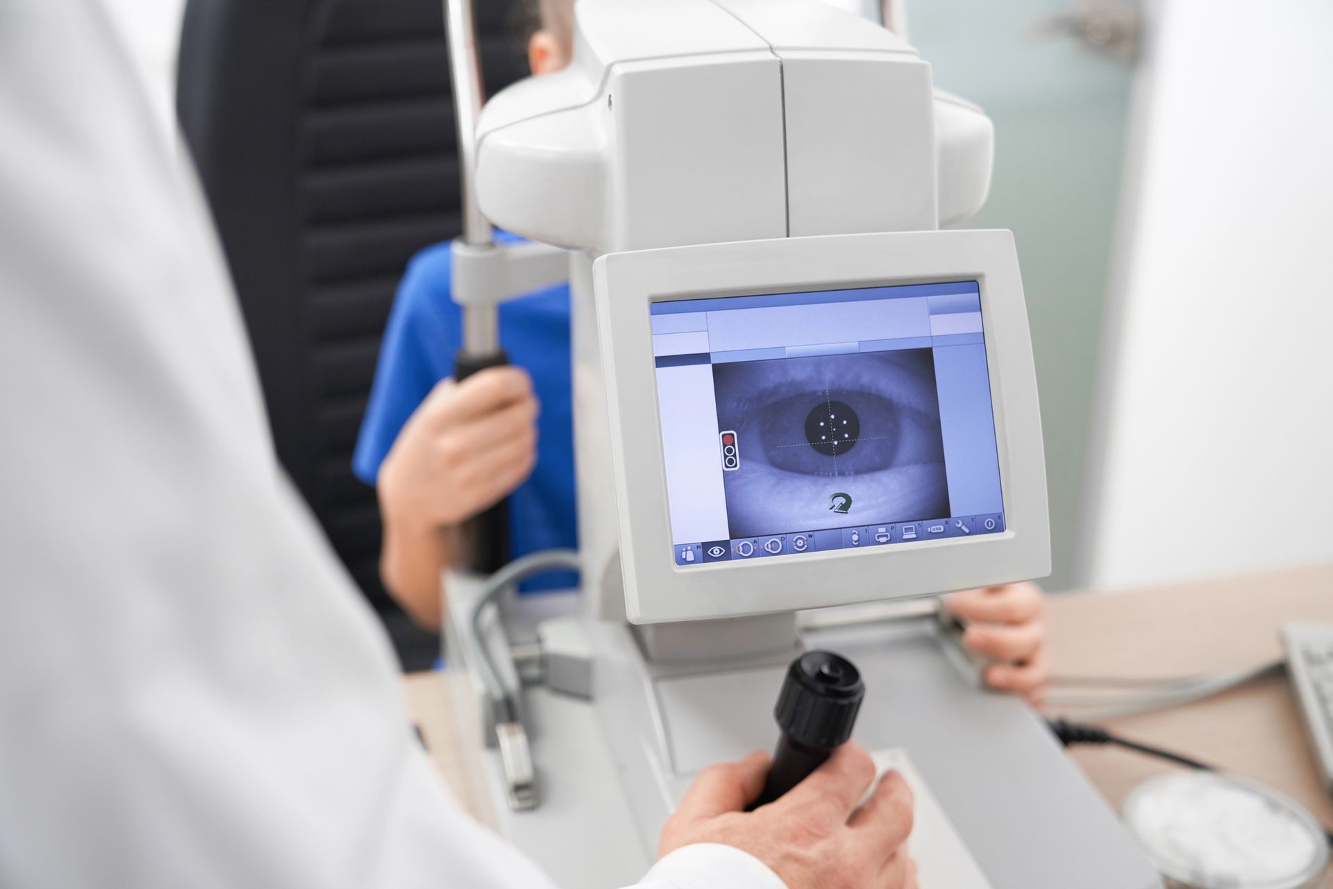 A doctor is examining a child 's eye with a machine.