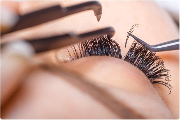 A close up of a person getting their eyelashes done.