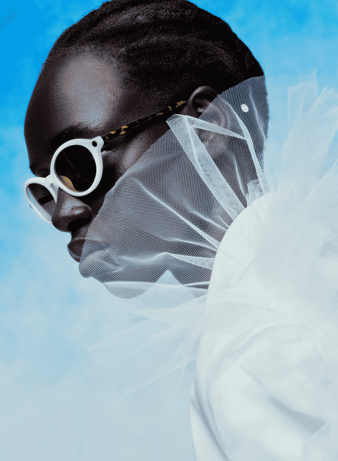 Profile portrait of a person in white sunglasses and a sheer white ruffled collar against a blue background