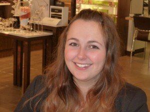 A woman is smiling for the camera in a store.