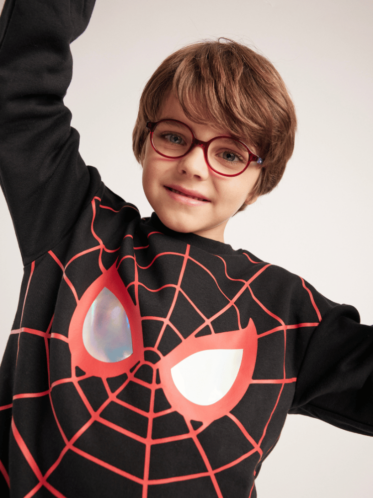 A boy wearing glasses in a Spiderman custom