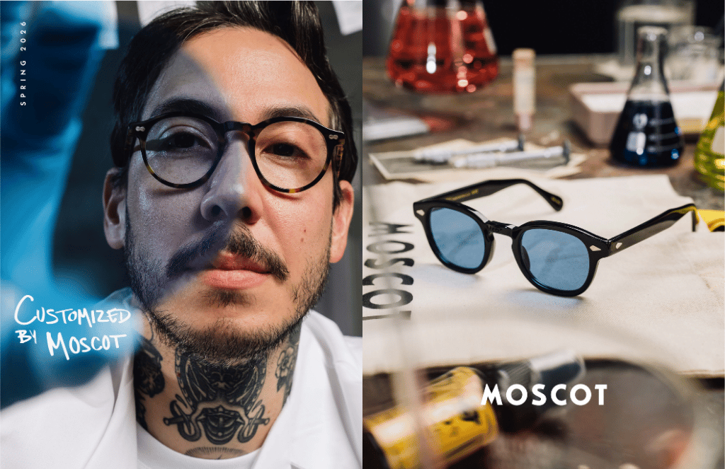 Portrait of a man with glasses beside MOSCOT eyeglasses and tools on a workbench