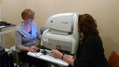 A woman is getting her eyes checked by an ophthalmologist.