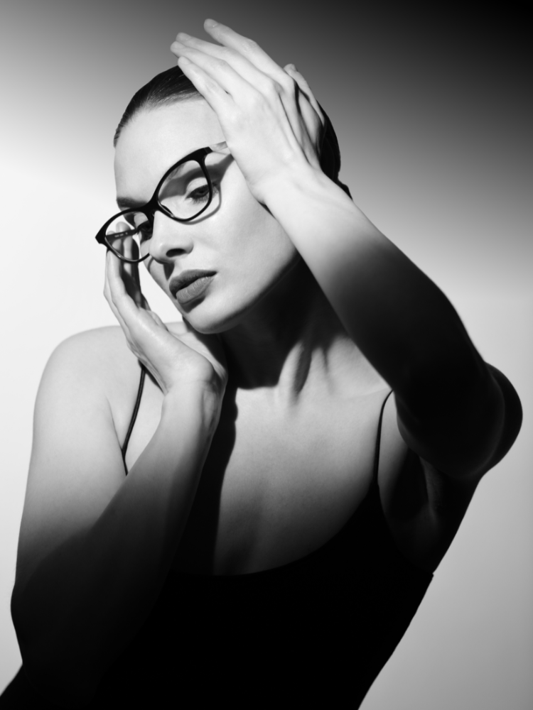 A black and white photo of a woman wearing glasses