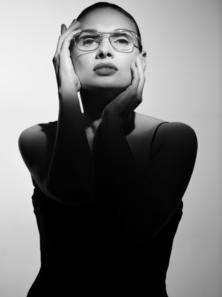 A black and white photo of a woman wearing glasses
